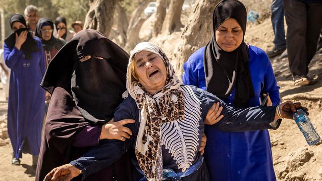 A woman is helped as she reacts to the death of relatives in an earthquake in the mountain village of Tafeghaghte, southwest of Marrakesh. Picture: AFP