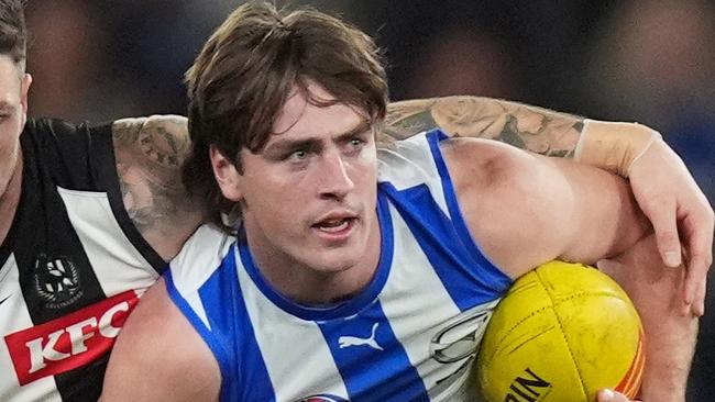 MELBOURNE, AUSTRALIA - JUNE 16: George Wardlaw of the Kangaroos is tackled by Jack Crisp of the Magpies during the round 14 AFL match between North Melbourne Kangaroos and Collingwood Magpies at Marvel Stadium, on June 16, 2024, in Melbourne, Australia. (Photo by Daniel Pockett/Getty Images)