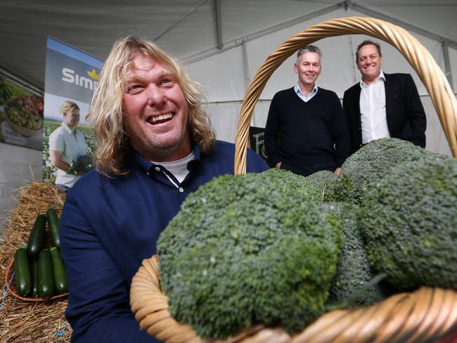 (L-R) Vegetable producer Stuart Greenhill with Coles Managing Director John Durkan and Simplot Managing Director Terry O'Brien after the announcement of the new contract at Quoiba. Picture Chris Kidd