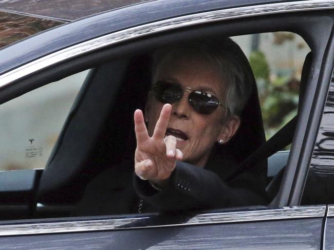 Jamie Lee Curtis flashes the peace sign as she leaves the intimate ceremony. Picture: AP/Reed Saxon