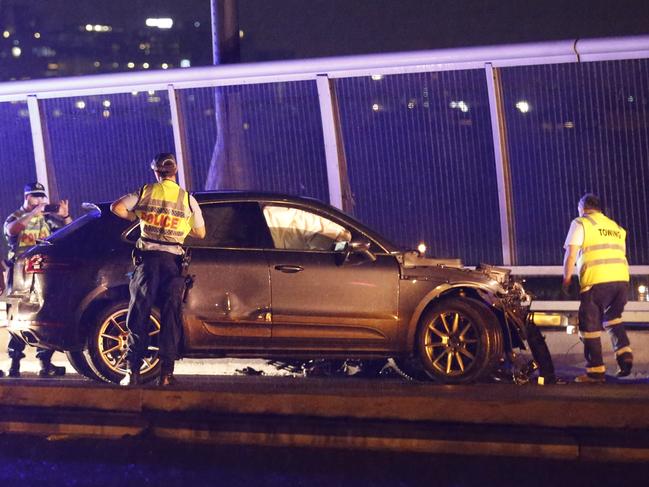 Police and fire rescue collected evidence and clear debris after a police pursuit ended in an mva on the Anzac bridge in the city  Picture : Steve Tyson