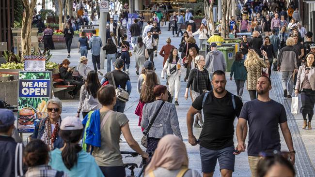 Pedestrians throng Brisbane’s CBD on Monday as retailers fling open their doors and customers happily open their wallets. Picture: Glenn Hunt