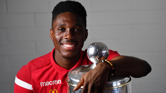 Adelaide United striker Al Hassan Toure with the FFA Cup he helped the Reds secure for a record third time. Picture: AAP Image/David Mariuz