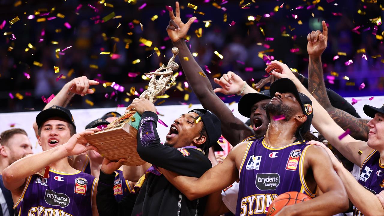 SYDNEY, AUSTRALIA - MAY 11: Jaylen Adams of the Kings lift the trophy as the Kings celebrate victory during game three of the NBL Grand Final series between Sydney Kings and Tasmania Jackjumpers at Qudos Bank Arena on May 11, 2022 in Sydney, Australia. (Photo by Mark Metcalfe/Getty Images)