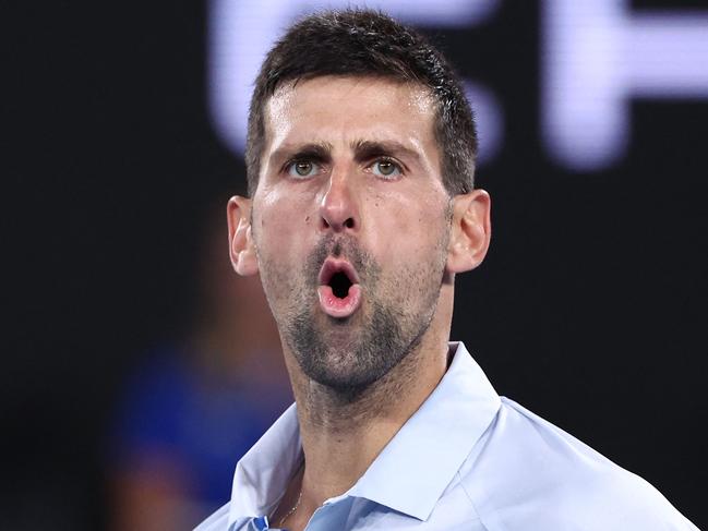 Serbia's Novak Djokovic reacts on a point against France's Adrian Mannarino during their men's singles match on day eight of the Australian Open tennis tournament in Melbourne on January 21, 2024. (Photo by David GRAY / AFP) / -- IMAGE RESTRICTED TO EDITORIAL USE - STRICTLY NO COMMERCIAL USE --