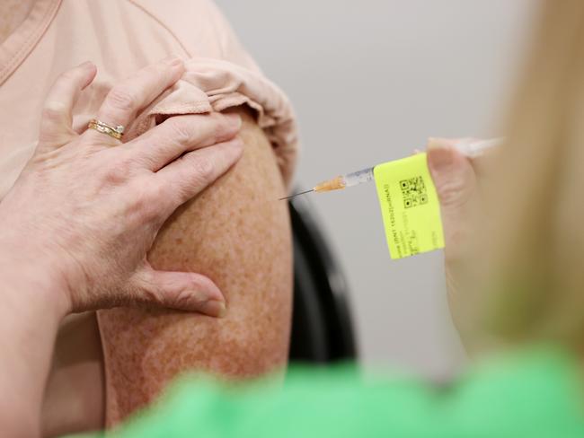 BRISBANE, AUSTRALIA - AUGUST 11:  Whitney McIntosh, 27, is seen receiving the Pfizer vaccination on the opening day of the COVID-19 vaccination hub at Brisbane Convention and Exhibition Centre on August 11, 2021 in Brisbane, Australia. The vaccination hub will provide the Pfizer vaccine and second dose of AstraZeneca to individuals with bookings as Queensland opens the vaccine registration list state-wide to anyone over 16. The Australian government says 70% of eligible Australians must be fully vaccinated before the country reopens. (Photo by Tara Croser - Pool/Getty Images)