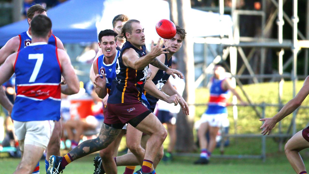 Lions' Harrison Sinclair-Stanley gets his hand to the ball first in the AFL Cairns Round 6 match between the Cairns City Lions and the Centrals Trinity Bulldogs, held at Holloways Beach. Picture: Brendan Radke