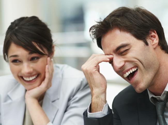 Business executive enjoying a laugh during a boardroom meeting