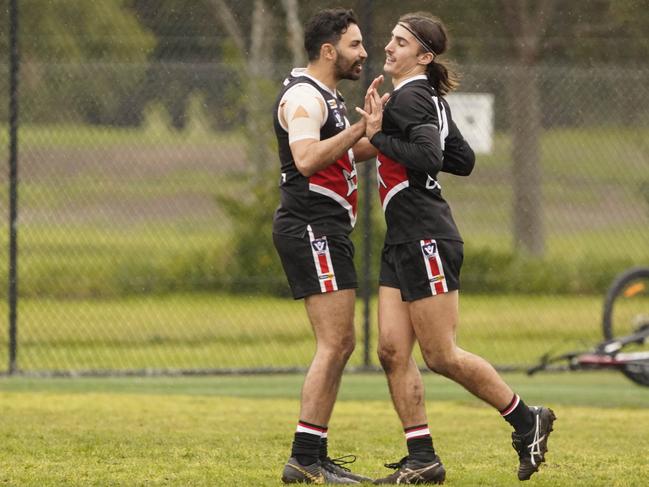 Trent Dennis-Lane (left) celebrates a goal.