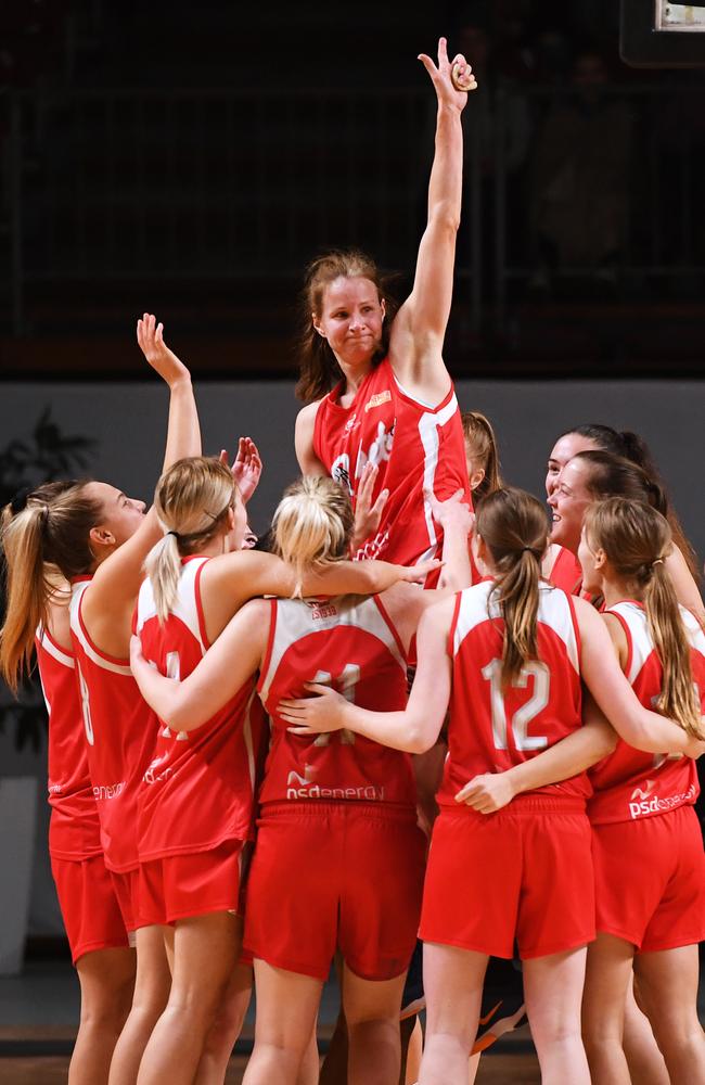 Jo Hill is raised by her teammates for her final game – and as a championship and grand final MVP winner – after North Adelaide’s 18-point victory over Forestville on Saturday night. Picture: AAP/Mark Brake.