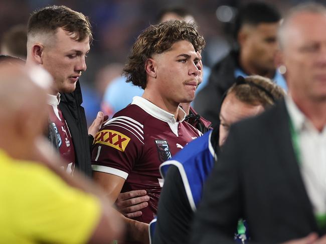 Reece Walsh is assisted from the field in Game 1. Picture: Cameron Spencer/Getty Images