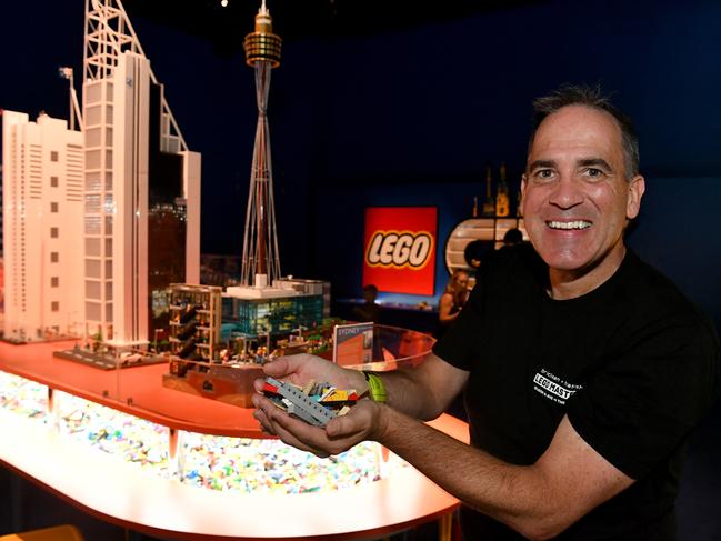 Ryan 'Brickman' McNaught with his exhibition 'Brickman Cities: Build on the Future' now on display at the Museum of Tropical Queensland. Picture: Evan Morgan