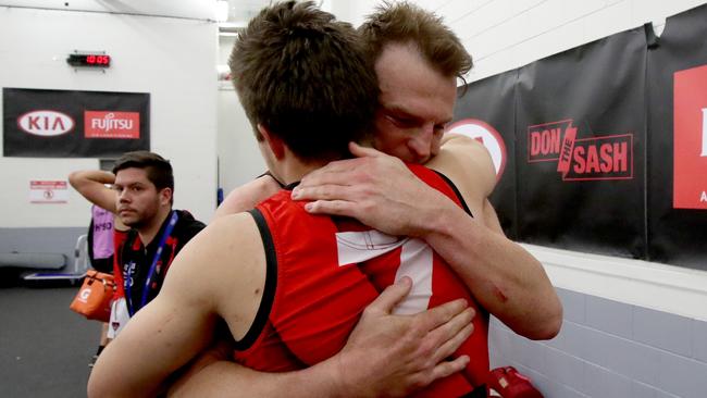 Brendon Goddard hugs Zach Merrett after the win over Port Adelaide.