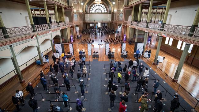 People wait to be vaccinated at the Royal Exhibition Building COVID-19 Vaccination Centre.