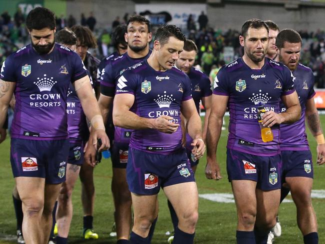 Cooper Cronk and Cameron Smith lead dejected Storm players off the field. Picture: Kym Smith