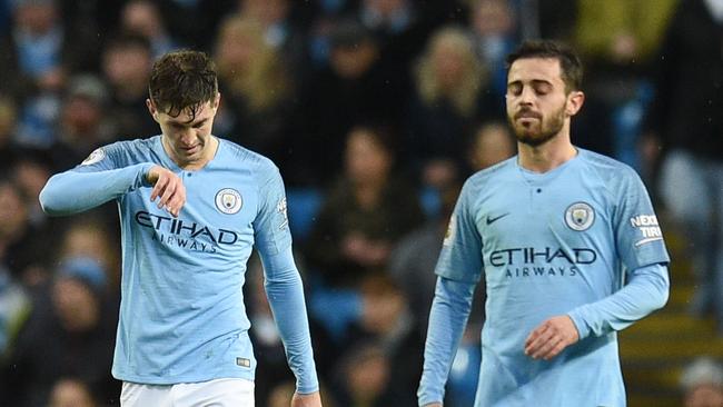 Manchester City's English defender John Stones (C) reacts after Crystal Palace's first goal during the English Premier League football match between Manchester City and Crystal Palace at the Etihad Stadium in Manchester, north west England, on December 22, 2018. (Photo by Oli SCARFF / AFP) / RESTRICTED TO EDITORIAL USE. No use with unauthorized audio, video, data, fixture lists, club/league logos or 'live' services. Online in-match use limited to 120 images. An additional 40 images may be used in extra time. No video emulation. Social media in-match use limited to 120 images. An additional 40 images may be used in extra time. No use in betting publications, games or single club/league/player publications. /