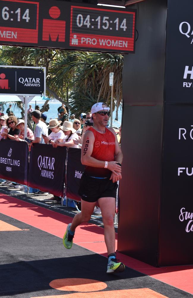 Athletes crossing the finish line at the Sunshine Coast Ironman 70.3 2023.