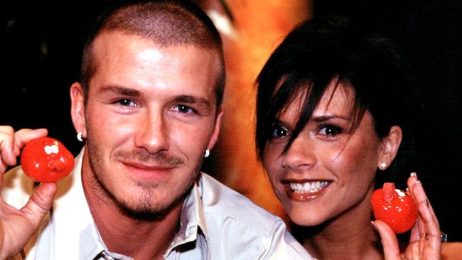 Not long after the Spice Girls announced their first break up, Posh and Becks posed for pictures for Red Nose Day. Picture: AP