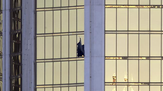 A broken window is seen at the Mandalay Bay Casino where a gunman opened fire on concert-goers. Picture: (AP Photo/Chris Carlson)