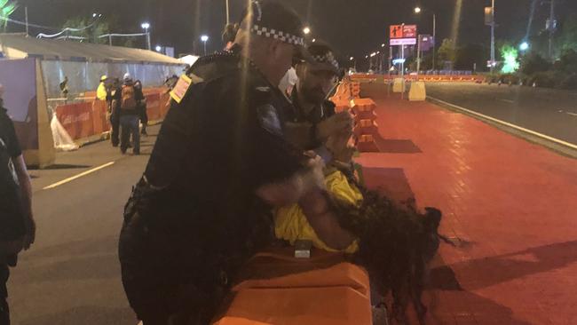 Aboriginal protesters are arrested by police at the Commonwealth Games opening ceremony. Photo: Britt Ramsey