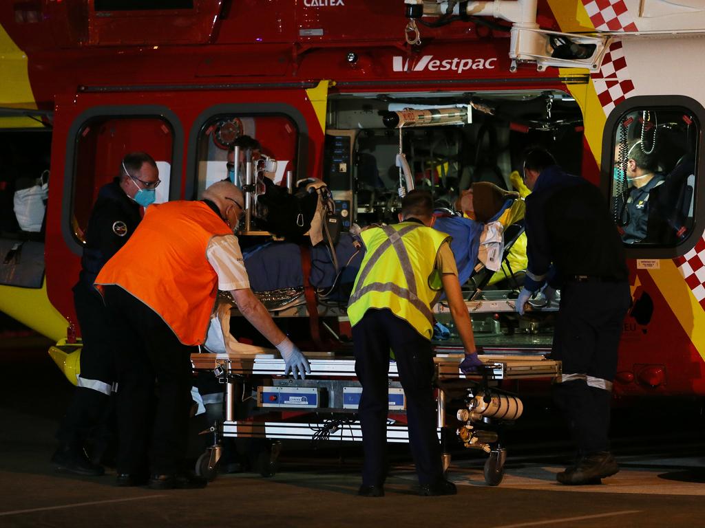 The shark attack victim arrives at John Hunter Hospital from Crescent Head. Picture: Peter Lorimer.