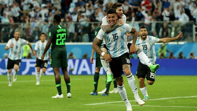 Messi and Marcos Rojo celebrate Argentina’s late winner which sent them through to the round of 16.