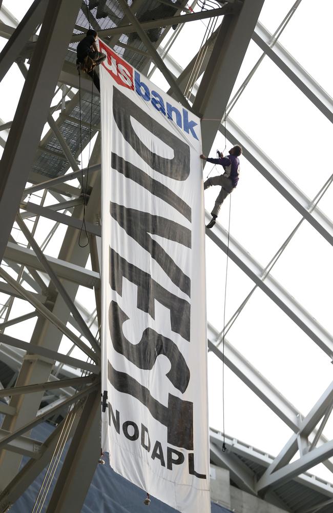 Protesters against the Dakota Access Pipeline rappel from U.S. Bank Stadium.