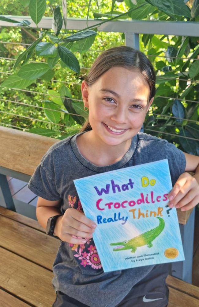 Young Territorian author Freya Galati with her award-winning book, ‘What do crocodiles really think?’. Picture: Supplied.