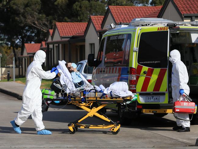 24/07/20 Paramedics leave with an elderly patient from St Basil's nursing home in Fawkner. Aaron Francis/The Australian