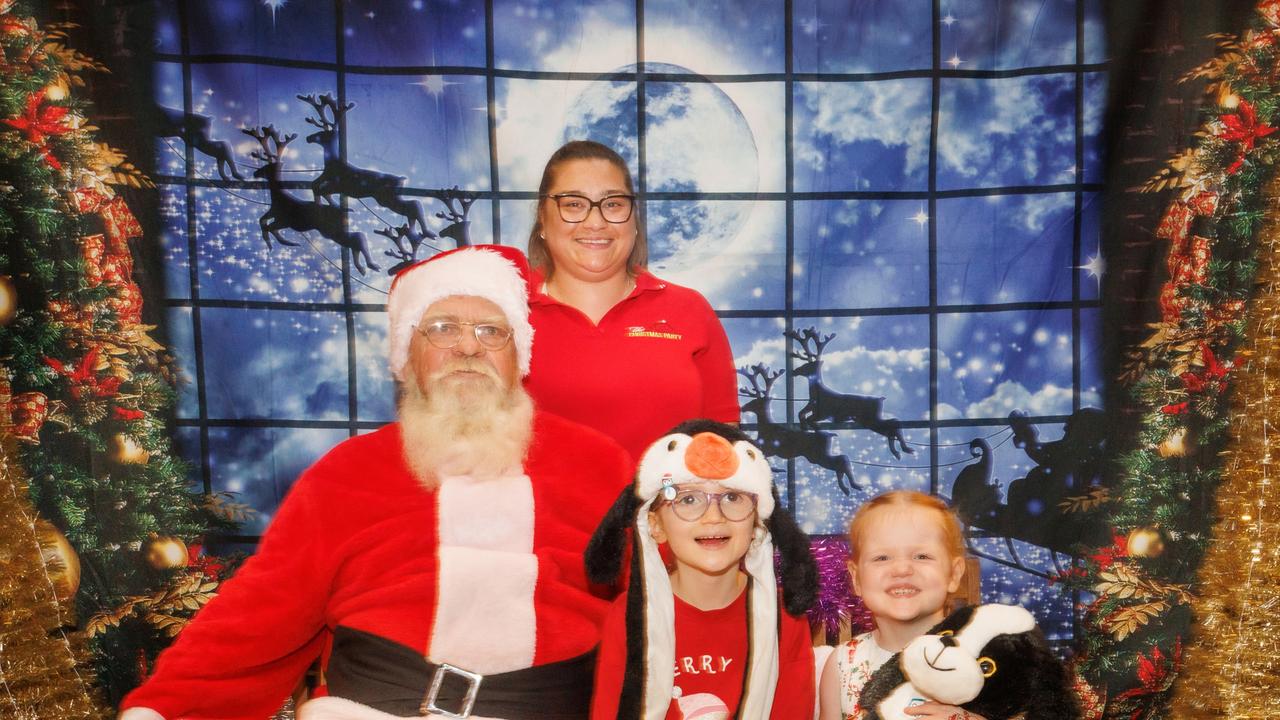 Santa at the Cairns Special Children's Christmas Party with event director Ally Young joined by special kids Madeleine and Charlotte Armistead. Picture: Colyn Huber