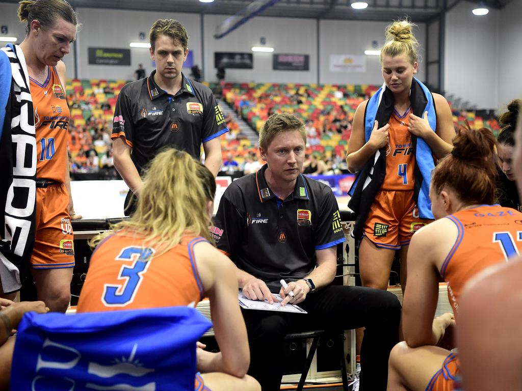 Townsville coach Shannon Seebohm and assistant Mason Rogers during a half-time talk in last year’s WNBL grand final. (Photo by Ian Hitchcock/Getty Images)