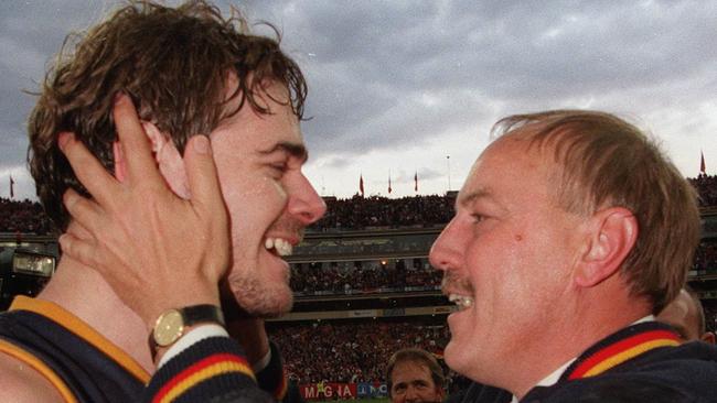 Master coach Malcolm Blight celebrates Adelaide’s 1997 grand final win against St Kilda with ruckman David Pittman at the MCG.