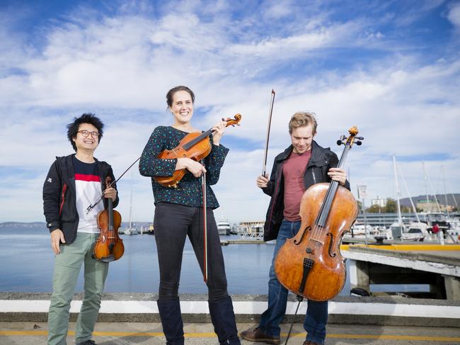 TSO musicians Hayato Simpson, Stefanie Farrands and Jonathan Bekes on Hobart’s waterfront in 2019. Picture: Richard Jupe