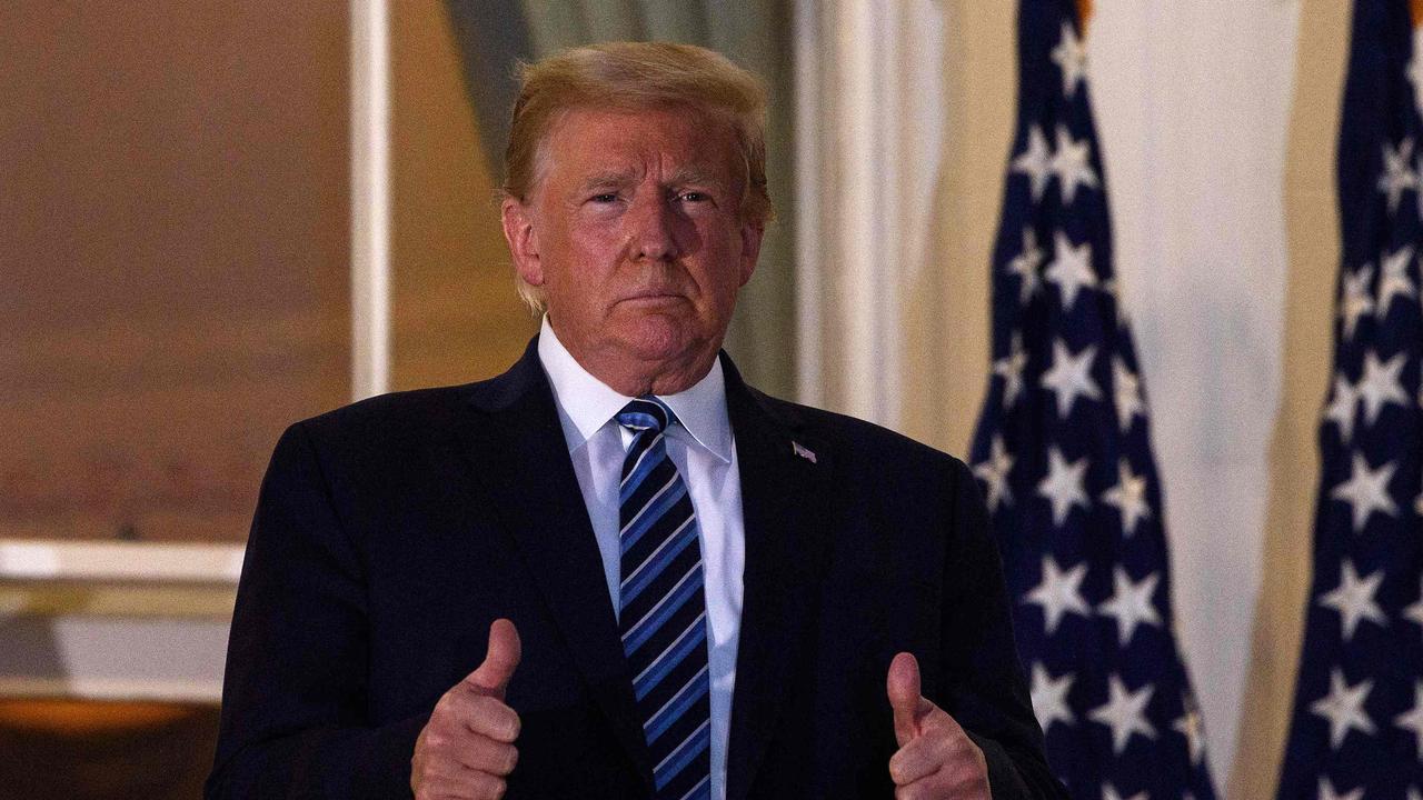 US President Donald Trump gives two thumbs up from the Truman Balcony upon his return to the White House from Walter Reed Medical Center, where he underwent treatment for COVID-19. Picture: NICHOLAS KAMM / AFP.