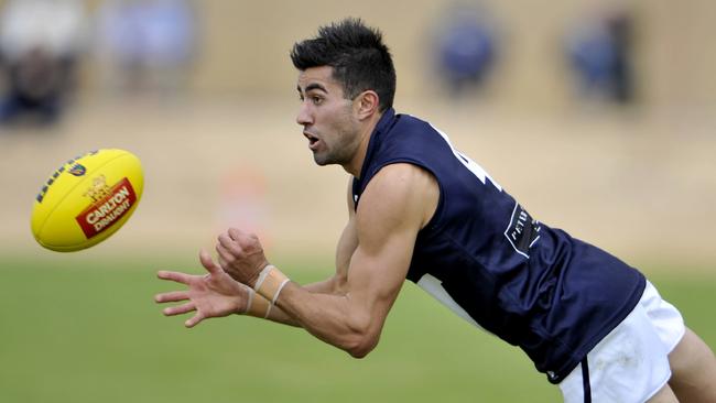 Chris Michaliades gets busy for Victoria in the 2013 state match against WA. He kicked two goals.