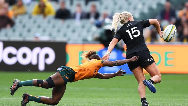 ADELAIDE, AUSTRALIA - AUGUST 27: Grace Steinmetz of the Black Ferns passes tackled by Ivania Wong of the Wallaroos. (Photo by Mark Brake/Getty Images)