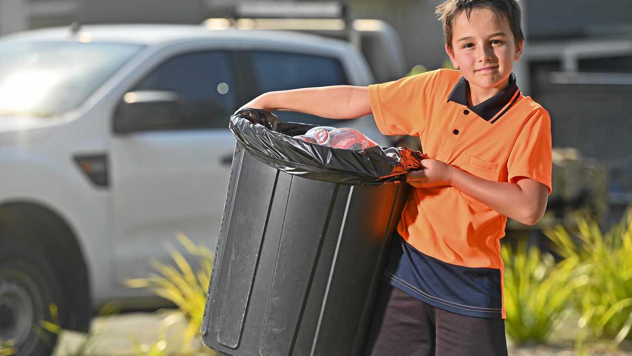 SMART SAVER: He's too young to get a job, but Cooper Riri, 8, has been doing rubbish runs with his father, Karl Riri, since mid-2018 to trade in his neighbours' rubbish for cash. Picture: Cordell Richardson