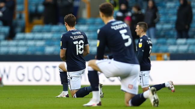 Millwall players kneel in a pre-game Black Lives Matter protest that was booed by some fans. Picture: Getty Images