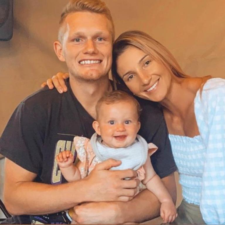 Adam Treloar, fiancee Kim, and daughter Georgie.