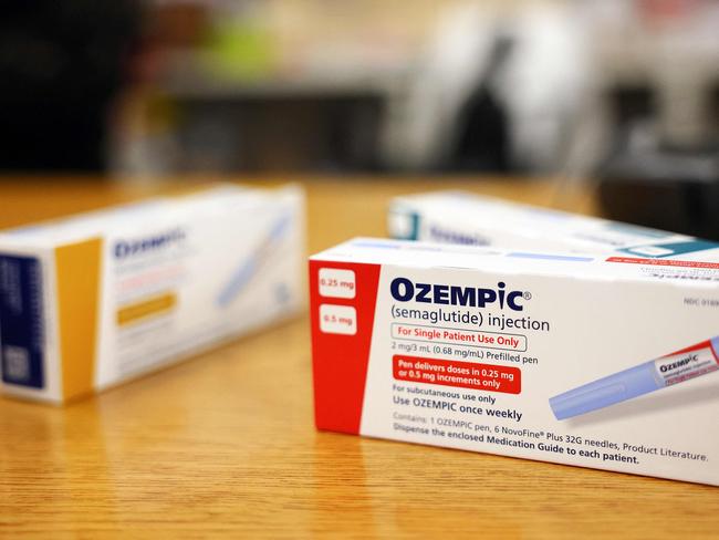 (FILES) This photo illustration shows boxes of the diabetes drug Ozempic resting on a pharmacy counter in Los Angeles, California, on April 17, 2023. Over 40 percent of Americans suffer from obesity, reflecting a major health crisis and the massive market for new Ozempic-type drugs. With their "groundbreaking" effectiveness, the drugs will be "the first line therapy for people who are obese," research physician Samuel Klein of Washington University in St. Louis told AFP. (Photo by MARIO TAMA / GETTY IMAGES NORTH AMERICA / AFP)