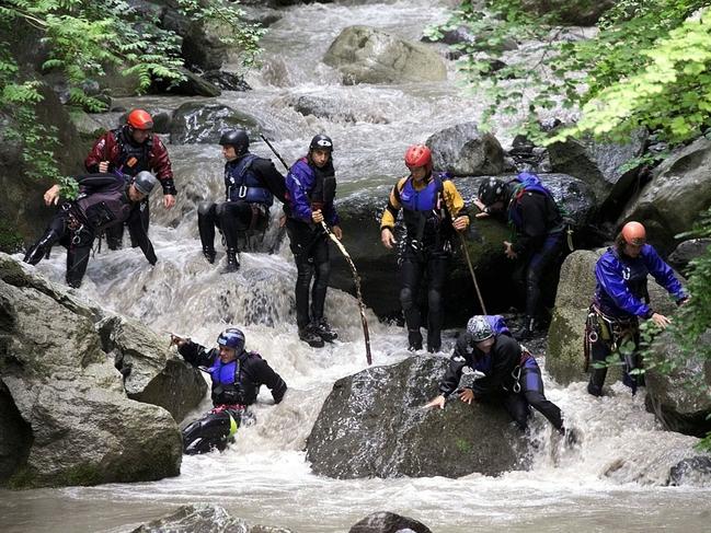 Rescue workers search for bodies in Saxetenbach Gorge on July 27, 1999.