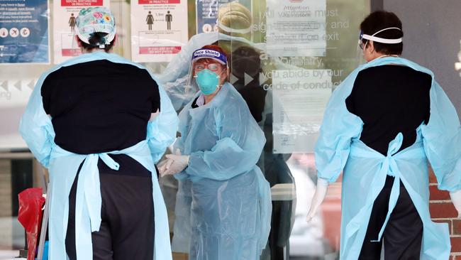 Health workers arrive at Arcare Maidstone on Tuesday. Picture: David Crosling