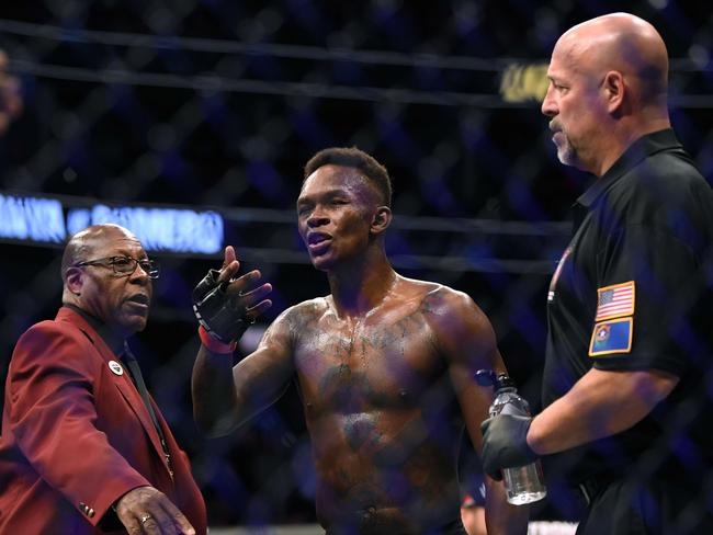 LAS VEGAS, NEVADA - MARCH 07: Israel Adesanya argues with Yoel Romero's corner after his decision win during a middleweight title bout at T-Mobile Arena on March 07, 2020 in Las Vegas, Nevada.   Harry How/Getty Images/AFP == FOR NEWSPAPERS, INTERNET, TELCOS & TELEVISION USE ONLY ==