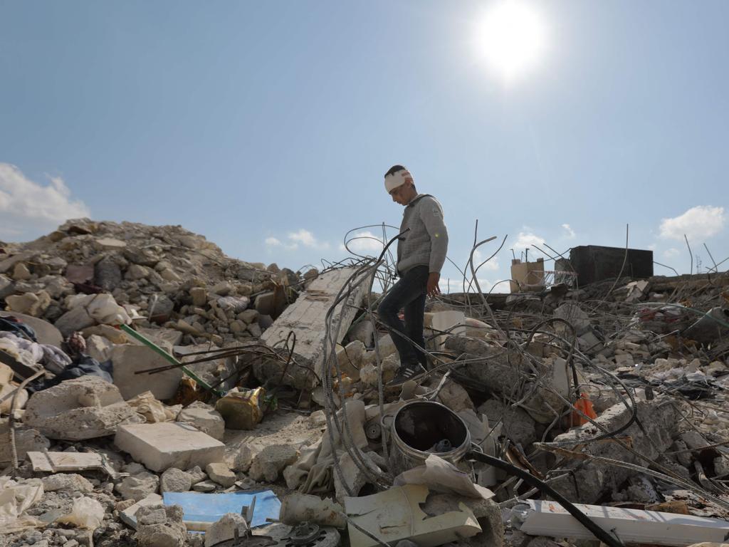 A Syrian boy, who lost his family and was also wounded as a result of the deadly earthquake that struck Turkey and Syria, wanders amid the rubble of his family home in the town of Jindayris. Picture: AFP