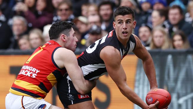 Nick Daicos of the Magpies looks to handball. Picture: Michael Klein