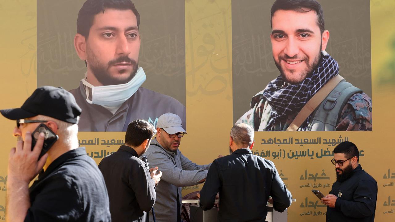 Hezbollah members and mourners attend a funeral of people killed in the attacks. Picture: Anwar Amro/AFP