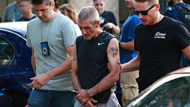 Craig Anderson (centre) being arrested a year before he was killed at his Doonside home. Picture: Adam Yip