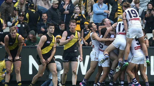 Fremantle players celebrate David Mundy’s match-winning goal as Richmond players realise they let one slip. Picture: Wayne Ludbey