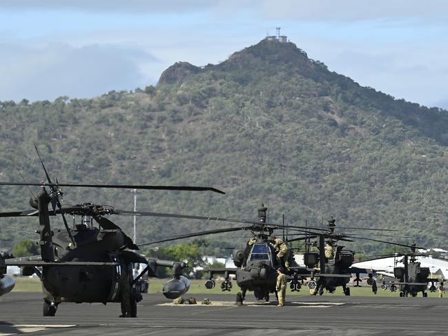 American Blackhawk and Apache helicopters from the 16th Combat Aviation Brigade (CAB) are seen lined up at the Townsville airport as part of exercise 'Talisman Sabre 23' on July 27, 2023. Picture: Ian Hitchcock/Getty Images