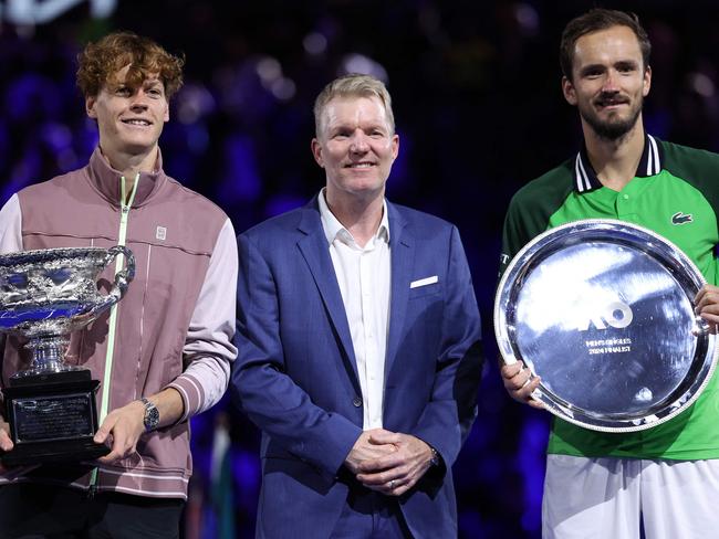 Italy's Jannik Sinner (L) and runner-up Russia's Daniil Medvedev pose for the pictures with former tennis player Jim Courier after their men's singles final match on day 15 of the Australian Open tennis tournament in Melbourne on January 29, 2024. (Photo by Martin KEEP / AFP) / -- IMAGE RESTRICTED TO EDITORIAL USE - STRICTLY NO COMMERCIAL USE --